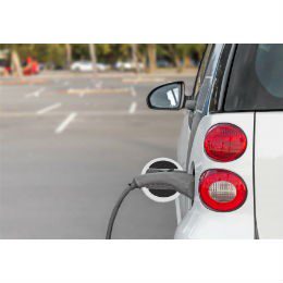 electronic car plugged in to charging outlet.