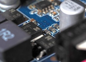 Low-angle close-up of a video card chip showing the board and capacitors.