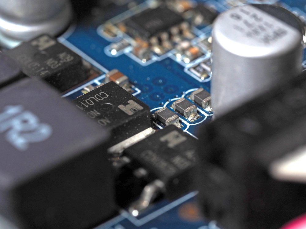 Low-angle close-up of a video card chip showing the board and capacitors.