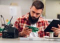 Engineer using a tablet to order electronic components online.