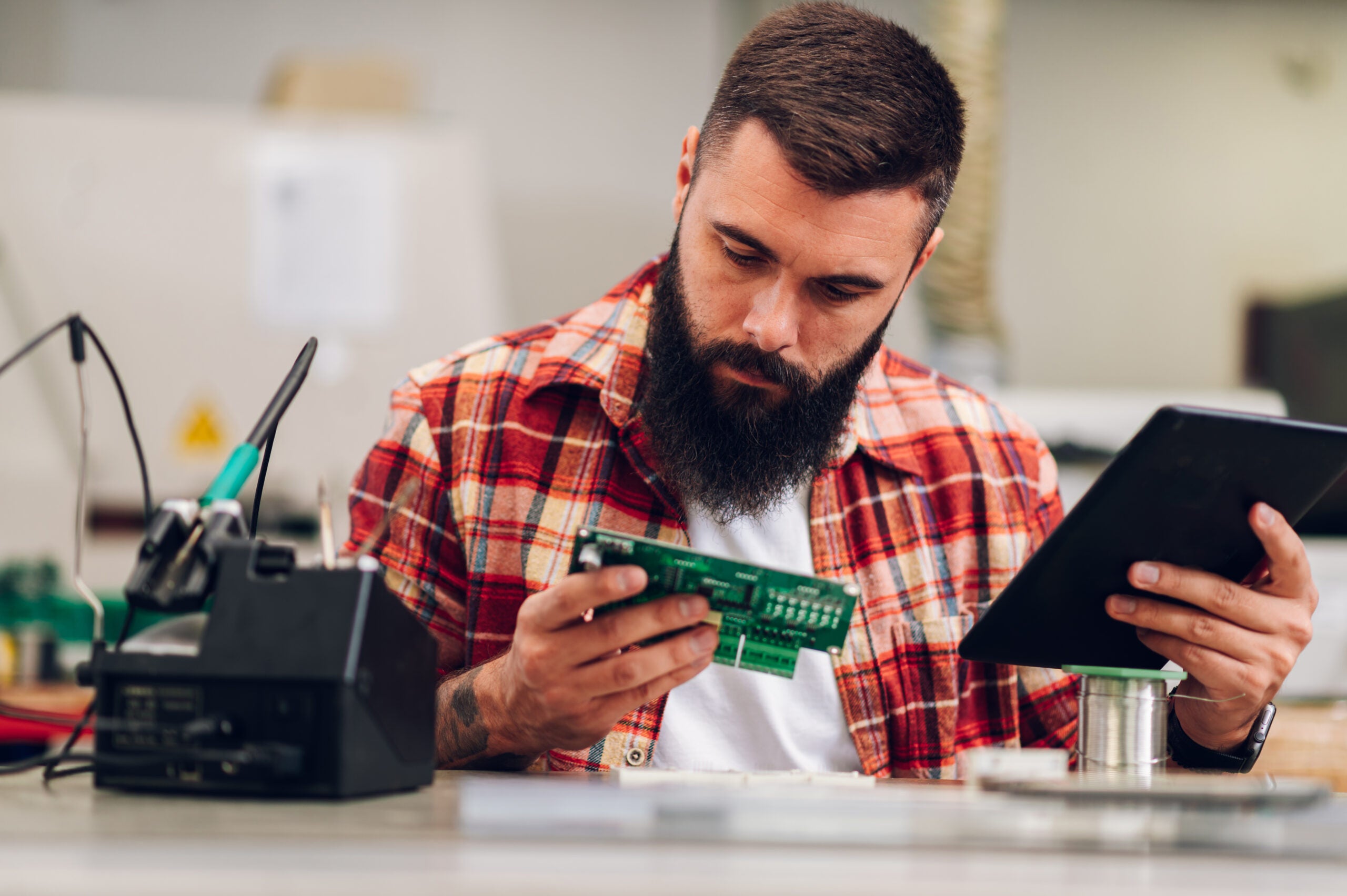 Engineer using a tablet to order electronic components online.