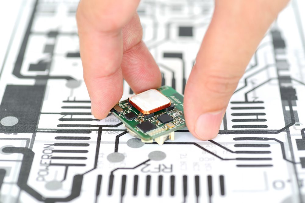 Hand picking up a PCB