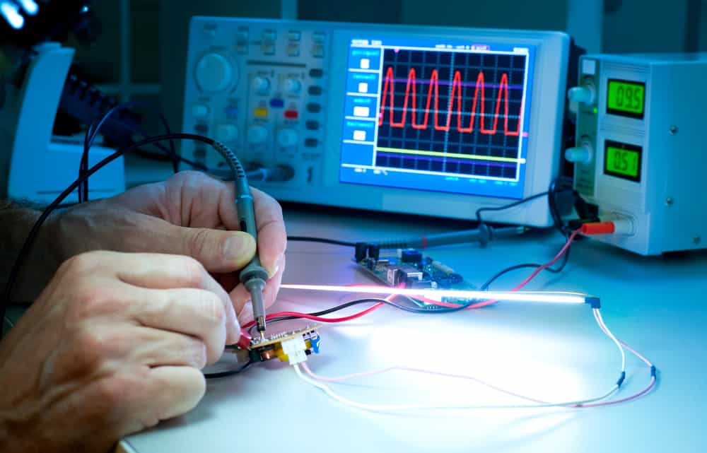 Technician testing electronic equipment