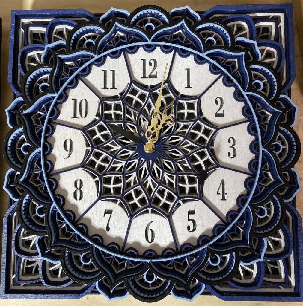 blue and white wooden laser cut clock