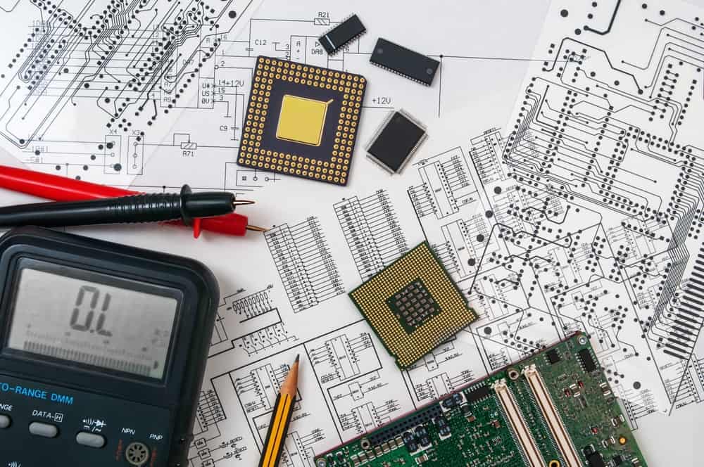 View of schematic, components, board, LCR meter indicating PCB development.