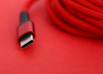 Red USB-C cable on a red background.