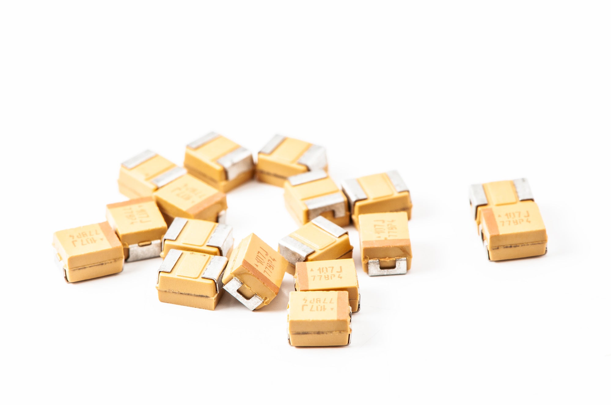 A view of tantalum capacitors that are often used for PCB layout bypass capacitors, on white background.